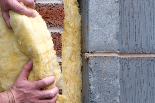 Exterior Home Insulation by worker